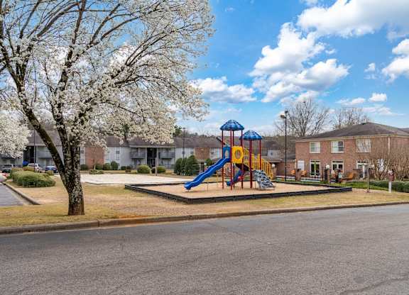 a playground in the middle of a street with houses at Ascot Place Apartments, Birmingham, AL 35235