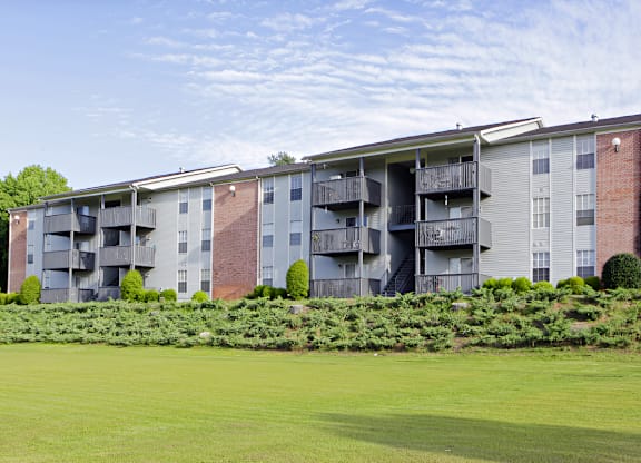 an apartment building with a green lawn in front of it at Ascot Place Apartments, Birmingham, AL 35235