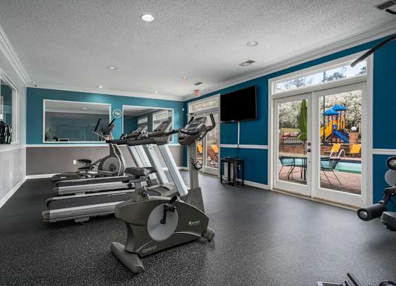 the gym at the landing has a view of the pool and playground at Ascot Place Apartments, Alabama, 35235