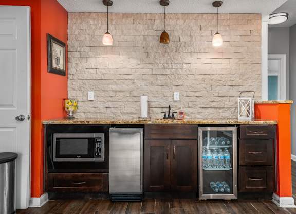 a kitchen with a counter with a refrigerator and a microwave at Ascot Place Apartments, Birmingham Alabama