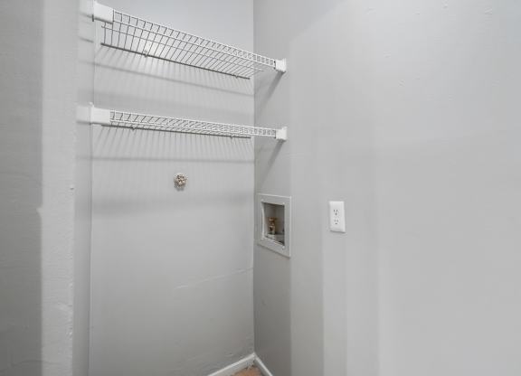 a walk in closet in a white room with a white wall and a white door at Ascot Place Apartments, Birmingham