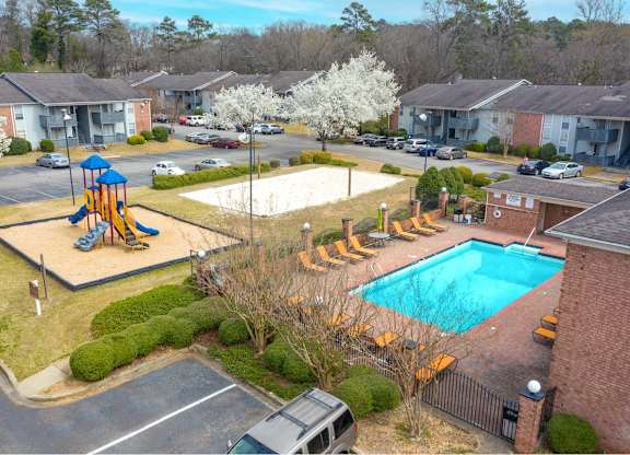 an aerial view of a swimming pool with playground equipment in a yard at Ascot Place Apartments, Birmingham Alabama