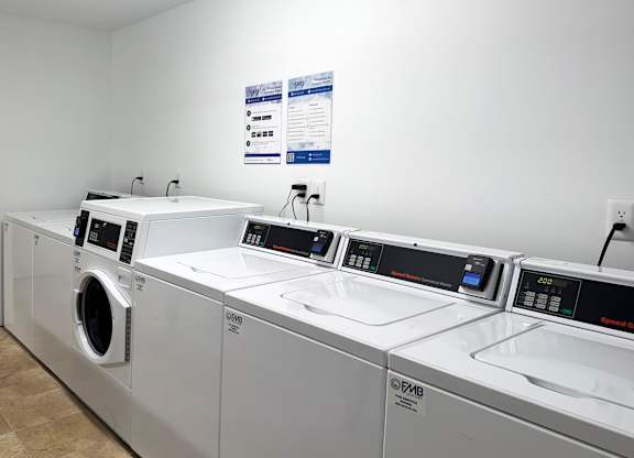 A row of washing machines and dryers at ascot place apartments