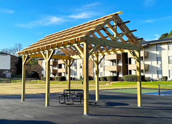 A wooden structure is being built in a park.
