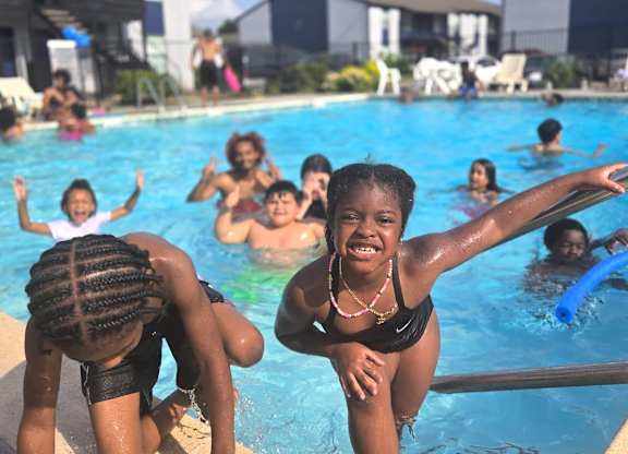 A group of people are enjoying a day at the pool.