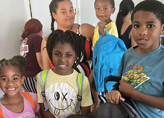 group of children holding backpacks at Crosby at Westchase Apartments, Houston