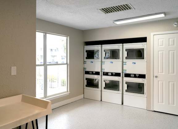 a room with a table and some microwaves in it