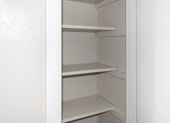 a deep linen closet with shelving