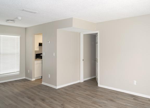 a 12th and beach living room with kitchen entrance and a doorway to the bedroom