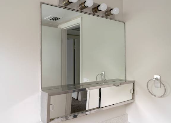A bathroom vanity with a mirror above it.