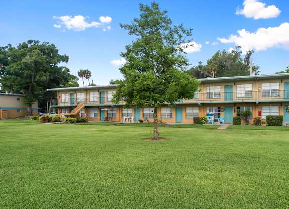 Park Apartments features a large grassy courtyard with trees throughout