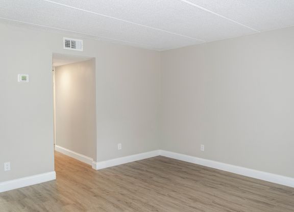 a large living room with wood-inspired flooring