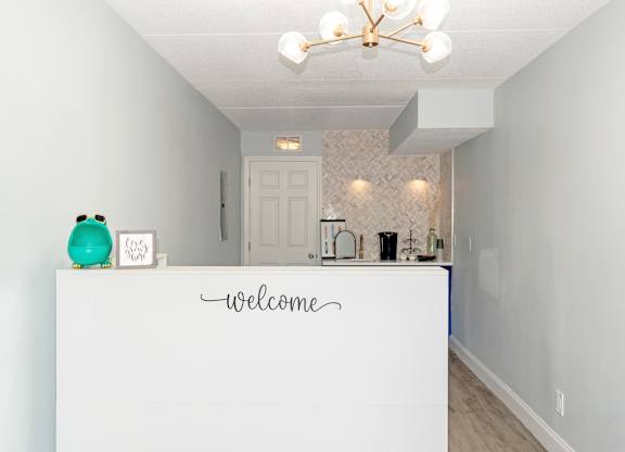 the office with a welcome desk and coffee bar at Ridge Apartments in South Daytona, FL