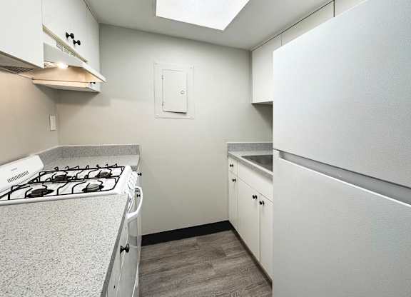Haven on Canal classic one-bed, one-bath kitchen with white appliances
