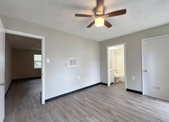 Haven on Canal classic one-bed, one-bath bedroom with a fan, closet, and bathroom access