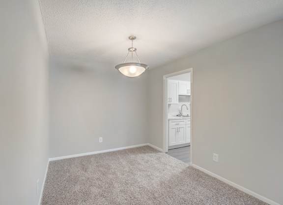 a dining room with a modern chandelier at Hills at Hoover 35216