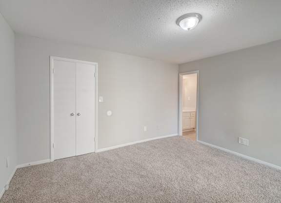 a bedroom with overhead lighting at Hills at Hoover Apartments 35216