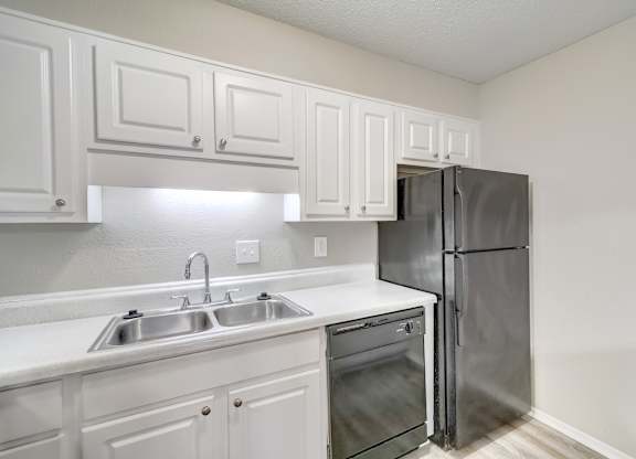 a modern, renovated kitchen with a dishwasher at Hills at Hoover 35216