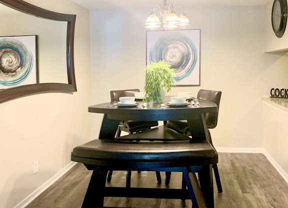 a dining area with model furnishings and decor at Hills at Hoover 35216