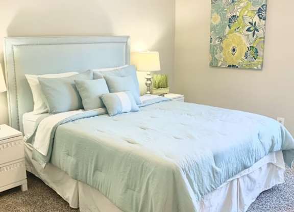 a bedroom with model furnishings at Hills at Hoover 35216