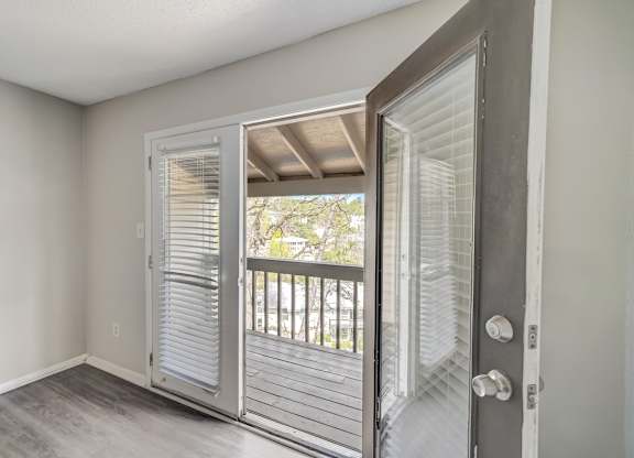 French doors from a living room to a private deck at Hills at Hoover 35216