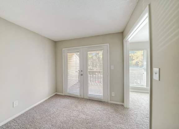 a dining and living area with french doors to a deck at Hills at Hoover 35216