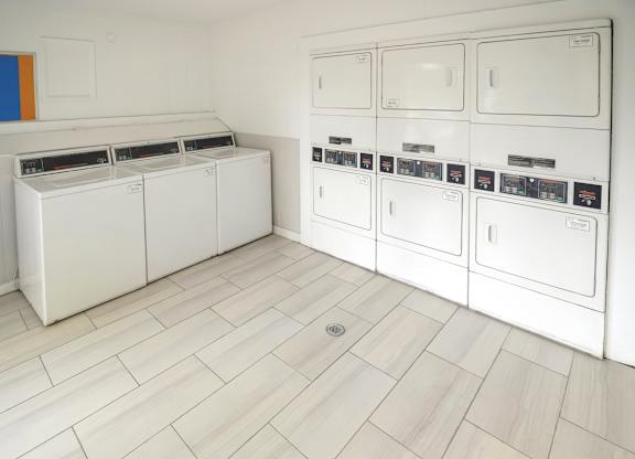 The laundry center with washers and dryers at Pine Creek Apartments