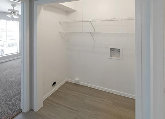 an area for a washer and dryer to be connected with built-in shelving in a Kirkwood Landing home