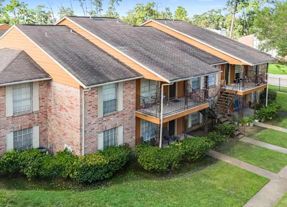 A residential building with lush landscaping and private patios and balconies at The Forest