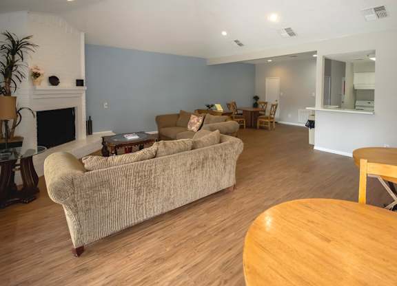 a resident lounge area with couch, fireplace, and kitchen in the Pine Creek clubhouse