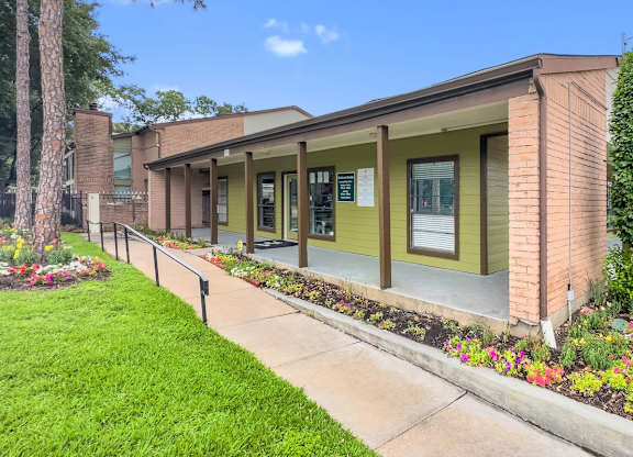 the exterior of the leasing office and clubhouse at Crosby at Westchase Apartments in Houston