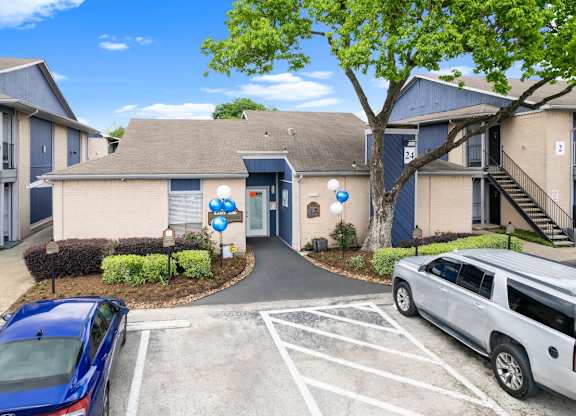 blue car is parked in a parking at Pine Creek Apartments, Houston, TX