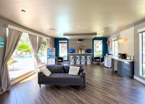 clubhouse with a couch, business center, and coffee bar at Hudson at Westchase Apartments