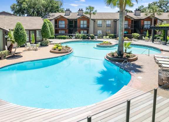 a lagoon style swimming pool at Hudson at Westchase Apartments in Houston