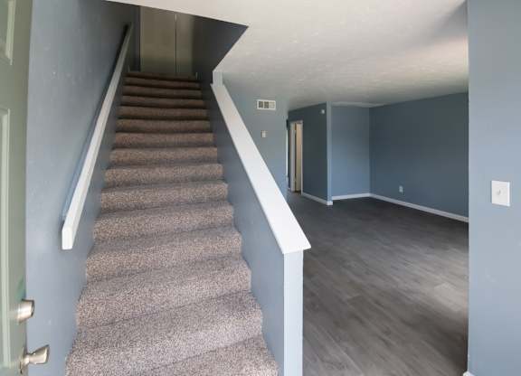 a two-story home with wood-style flooring and carpet at Winford Place Apartments in Orlando, FL
