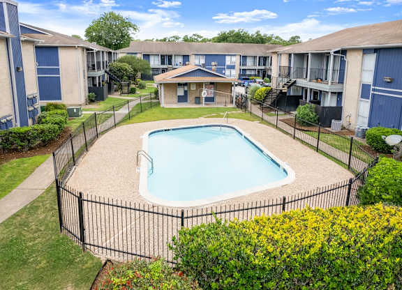 an aerial view a sparkling pool at Pine Creek Apartments in Houston