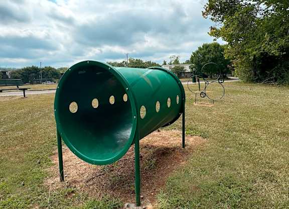 a green mailbox on the side of a park at Spring Lake Cove Apartments, Birmingham Alabama