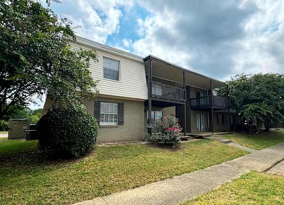 an apartment building with a sidewalk in front of it at Spring Lake Cove Apartments, Birmingham, AL