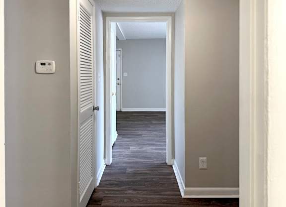 a hallway with a door and a light switch at Spring Lake Cove Apartments, Alabama, 35215