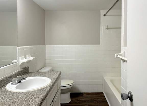 a bathroom with a sink toilet and a bath tub at Spring Lake Cove Apartments, Birmingham, 35215