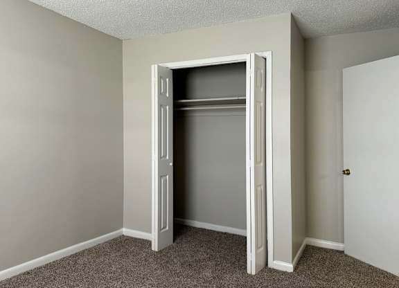 an empty closet in an empty room with a door open at Spring Lake Cove Apartments, Birmingham, AL