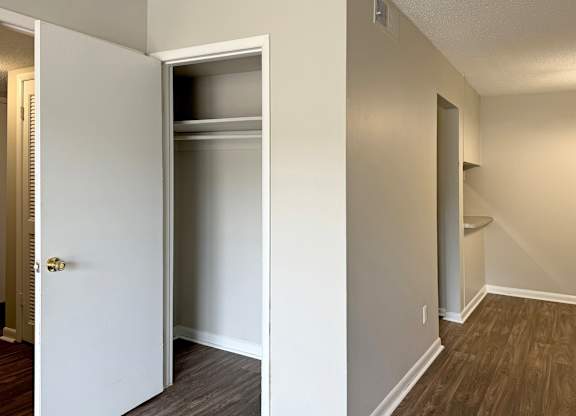 an empty room with a closet and a door open at Spring Lake Cove Apartments, Birmingham, 35215