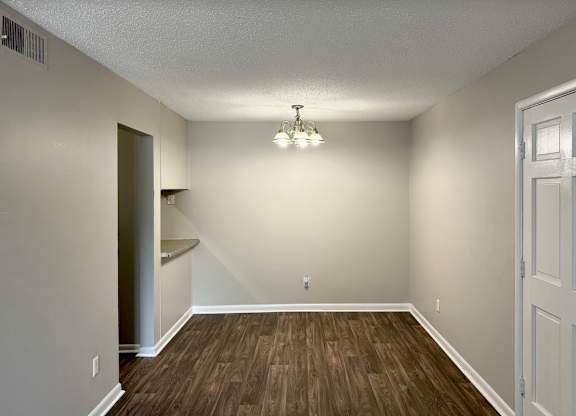 an empty living room with wood flooring and white walls at Spring Lake Cove Apartments, Alabama, 35215