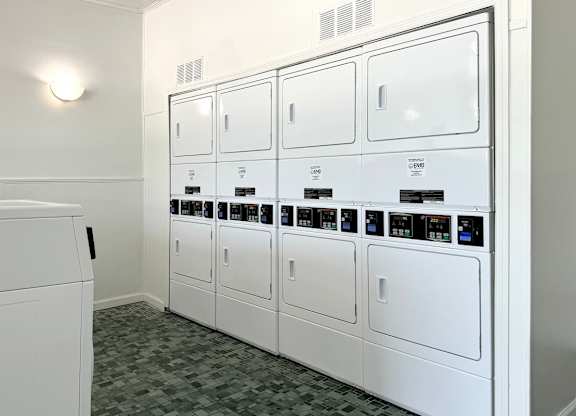 a row of white appliances in a laundry room at Spring Lake Cove Apartments, Birmingham, AL 35215