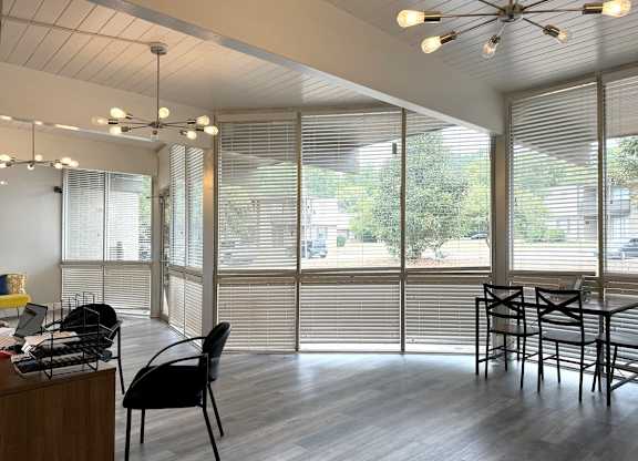 a dining room with windows and a table and chairs at Spring Lake Cove Apartments, Birmingham, 35215