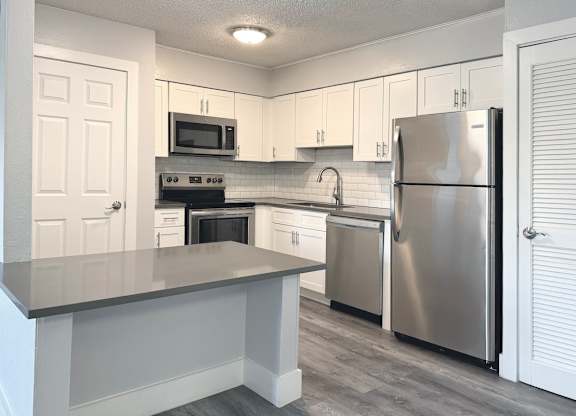 a kitchen with stainless steel appliances and white cabinets at Ascot Place Apartments, Alabama, 35235