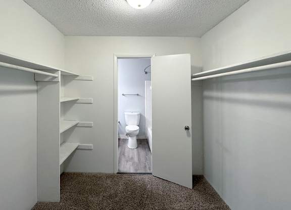 a bathroom with a toilet and a closet at Ascot Place Apartments, Birmingham, AL 35235