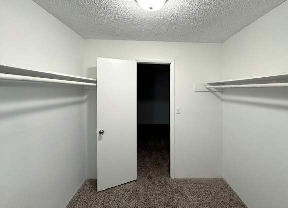 an empty closet in a room with a door open at Ascot Place Apartments, Birmingham, 35235