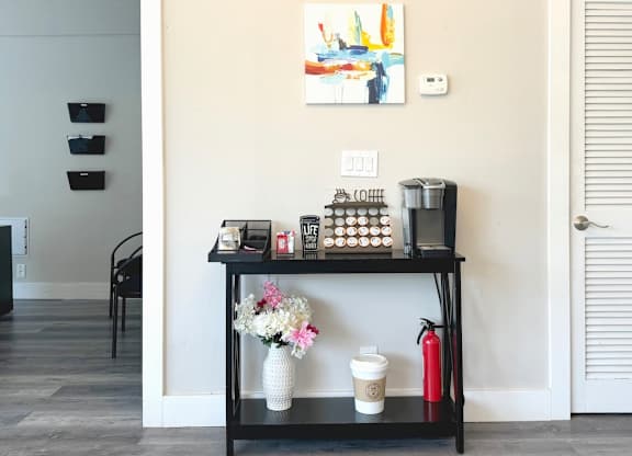 a black shelf with a coffee maker and other items on it at Spring Lake Cove Apartments, Birmingham Alabama