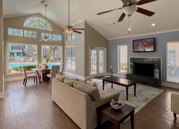the spacious and welcoming clubhouse interior with furnishings and a tv at Waters at Westchase